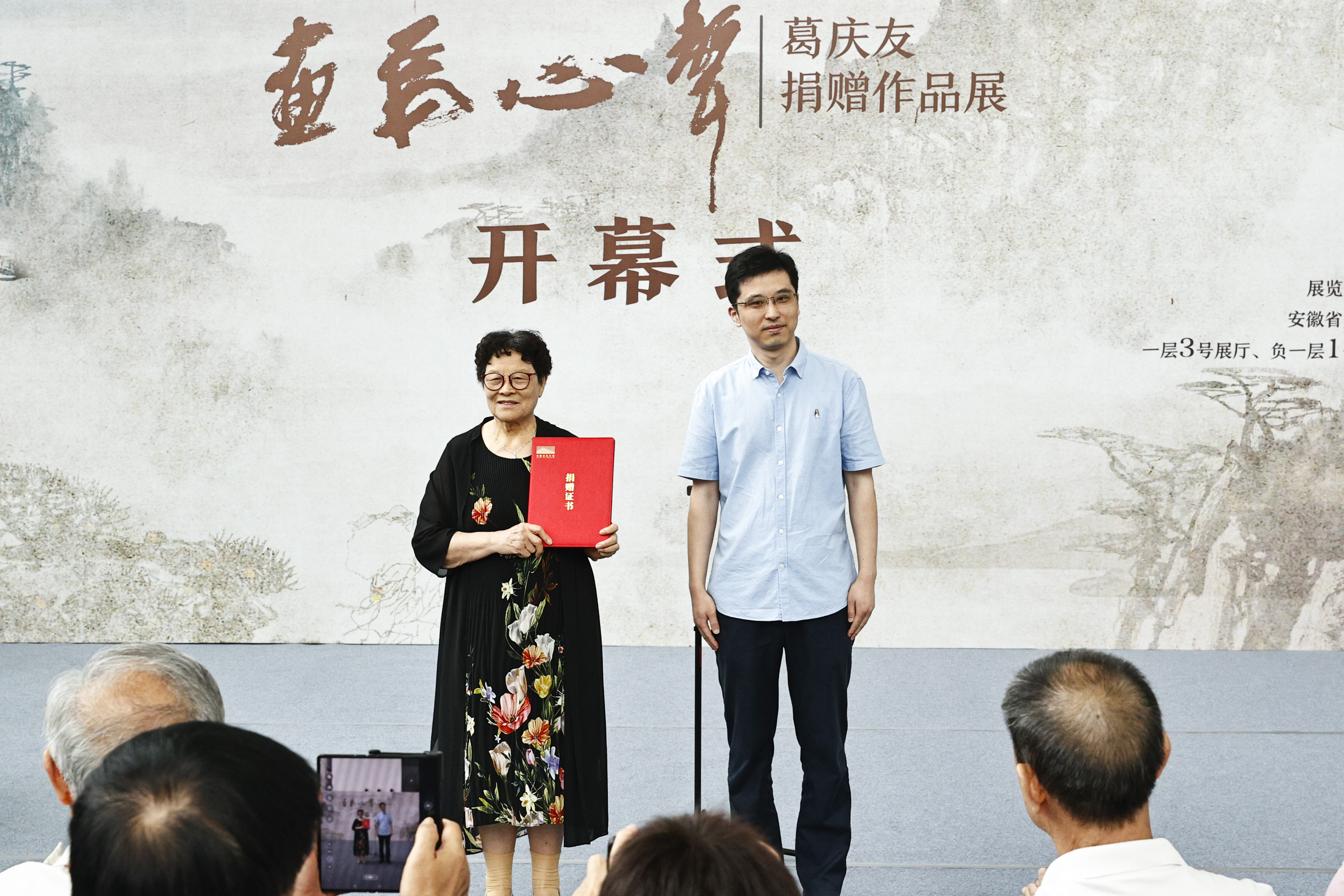 安徽省美术馆副馆长姜岱品为葛庆友家属孟凡玲女士颁发捐赠证书