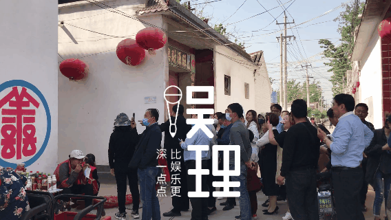 朱之文家门口的人群,以及他家门前堵车的路上